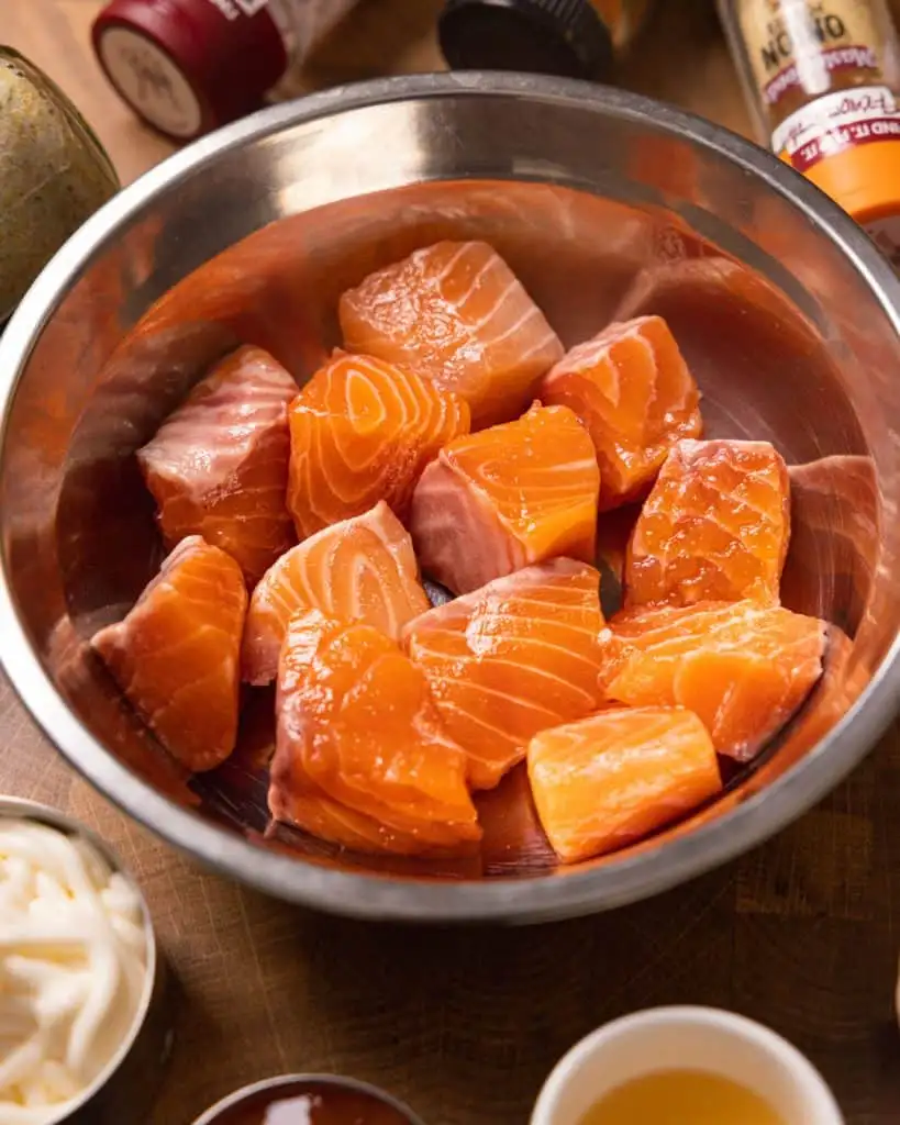 Fresh salmon cubes in a bowl for salmon recipe prep. - GENIUS EATS Salmon