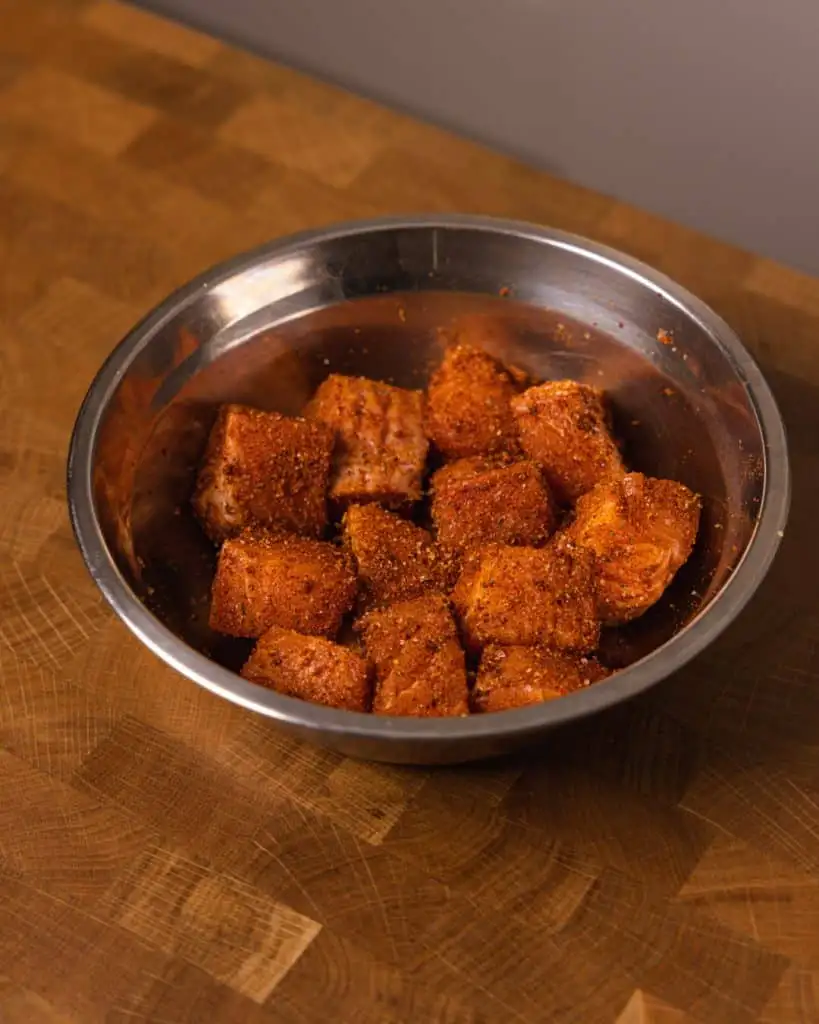 seasoned salmon cubes in mixing bowl - GENIUS EATS Salmon with spices