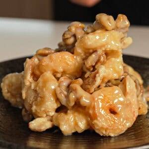 Creamy honey walnut shrimp piled on a plate.