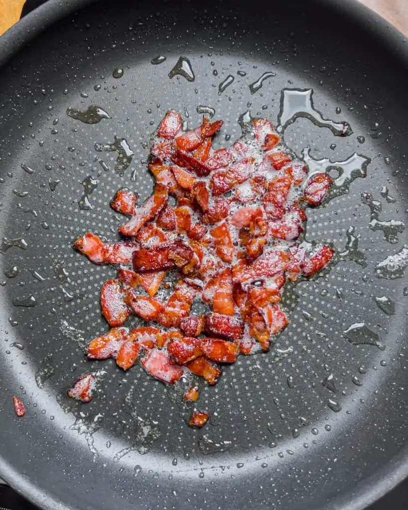 Crispy bacon pieces cooked in a pan - GENIUS EATS Crispy bacon pieces cooked in a pan