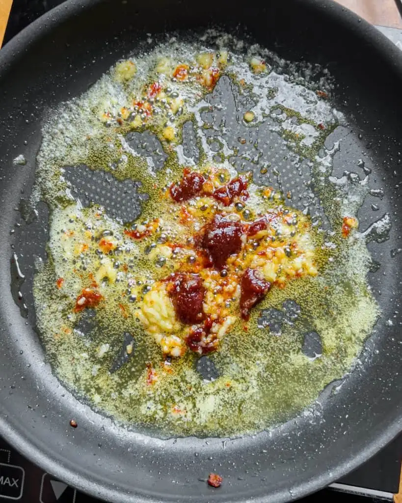 Garlic sautéing in melted butter with added kimchi - GENIUS EATS Garlic sautéing in melted butter with added kimchi