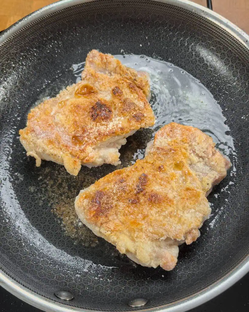 Golden-brown crisped chicken thighs cooking in the pan - GENIUS EATS Golden-brown crisped chicken thighs cooking in the pan
