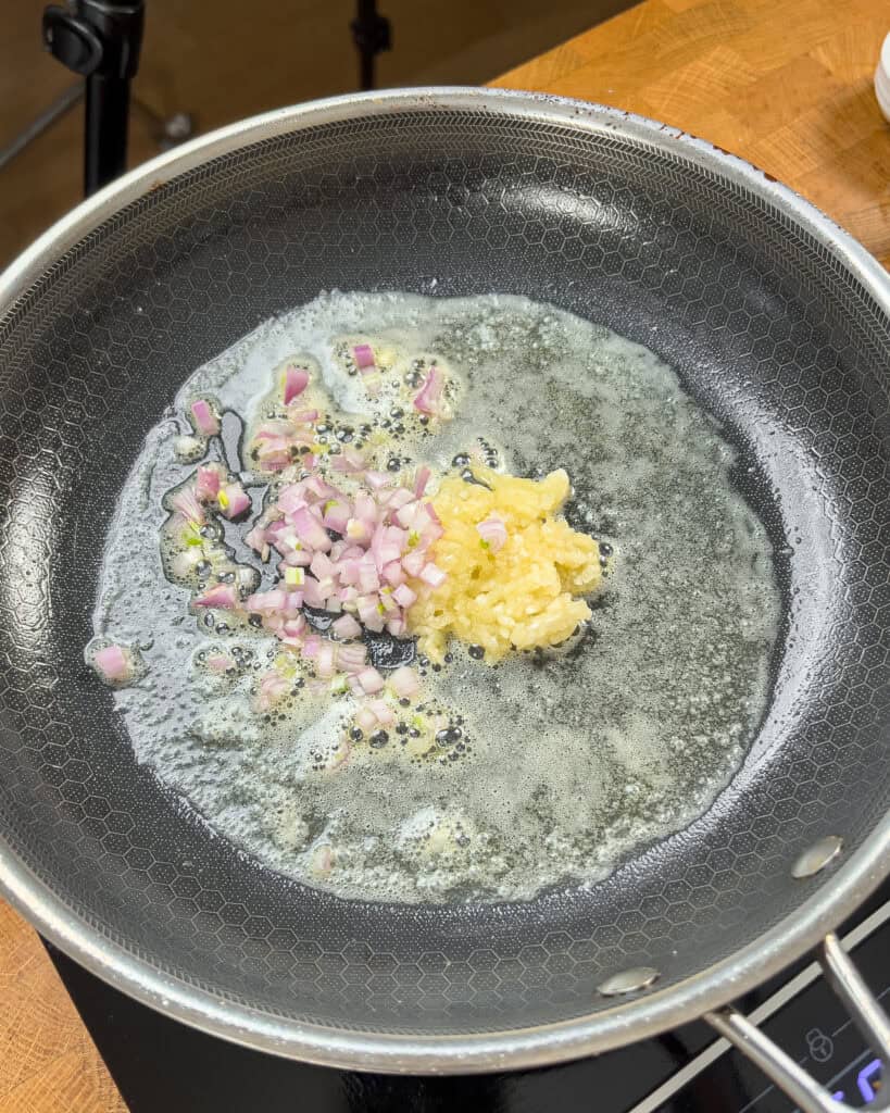 Minced garlic and diced shallot sizzling in melted butter