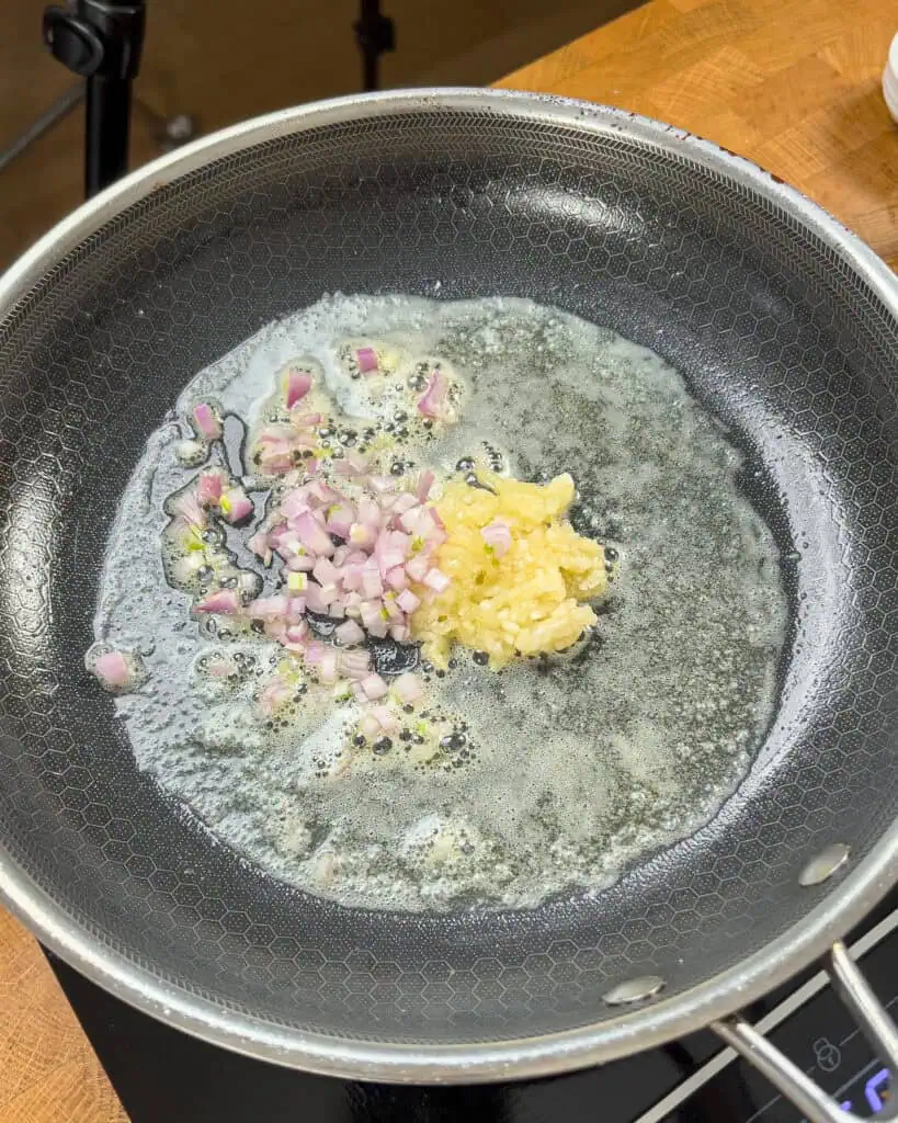 Minced garlic and diced shallot sizzling in melted butter - GENIUS EATS Minced garlic and diced shallot sizzling in melted butter