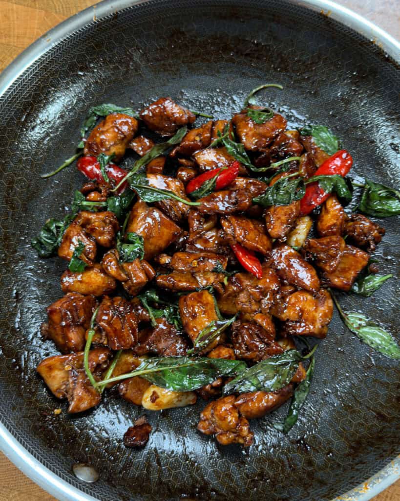 Thai basil-infused Three Cup Chicken with glossy sauce and red chilis