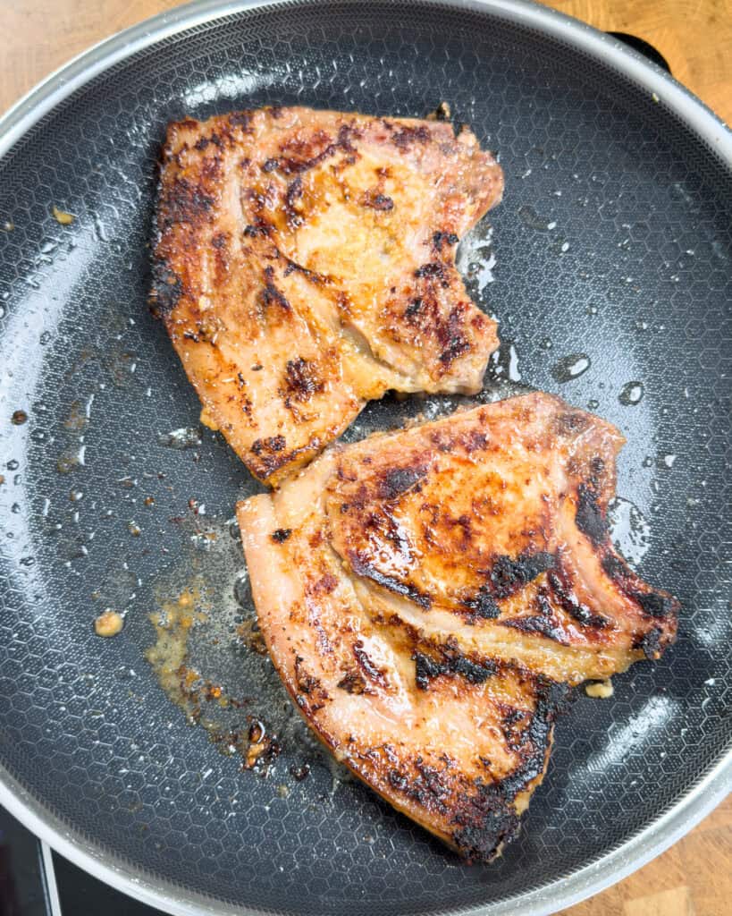 Pan searing Vietnamese lemongrass pork chops until caramelized