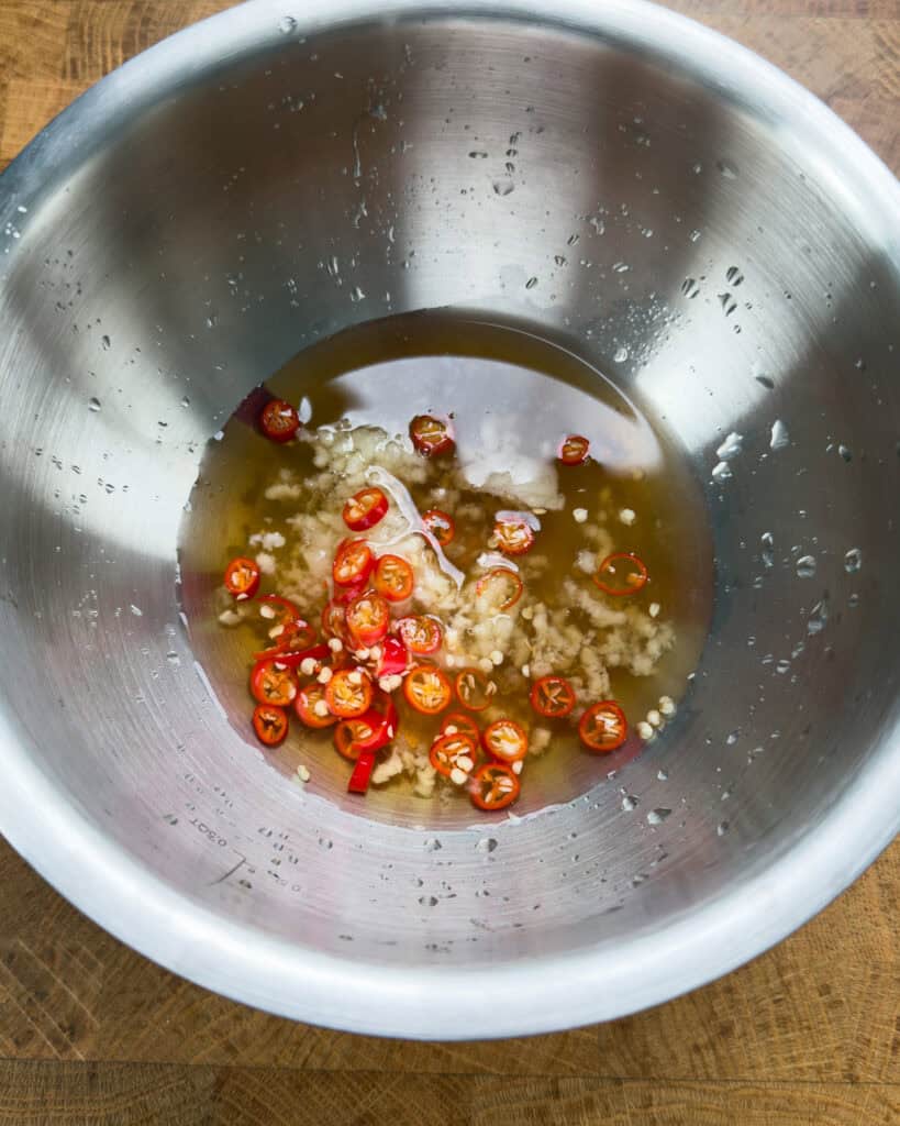Vietnamese lemongrass pork chop marinade with garlic and chilies in mixing bowl