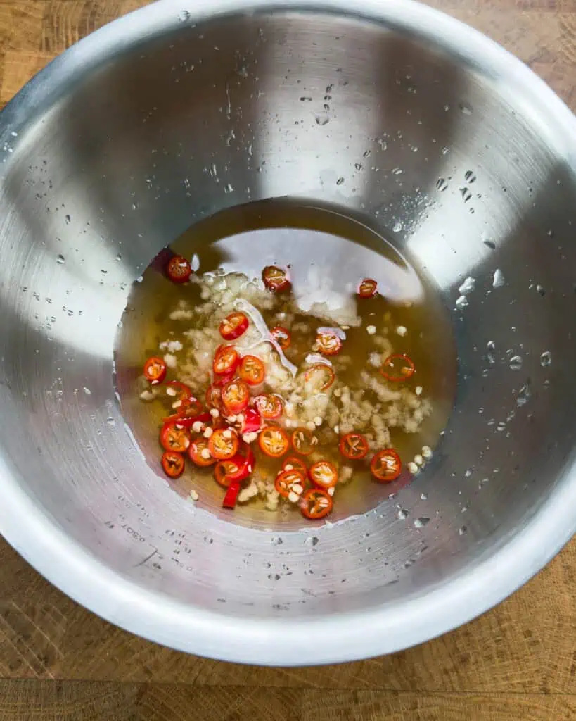 Vietnamese lemongrass pork chop marinade with garlic and chilies in mixing bowl - GENIUS EATS Vietnamese lemongrass pork chop marinade with garlic and chilies in mixing bowl