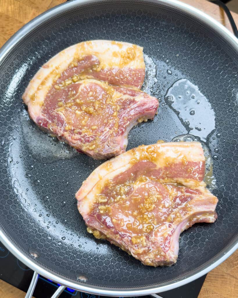 Vietnamese pork chops coated in marinade before cooking