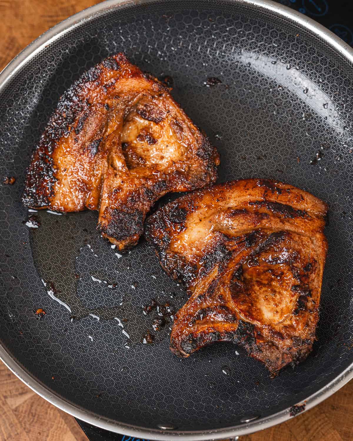 Seared pork chops with a caramelized crust cooked to perfection in a non-stick skillet. Ideal for a.