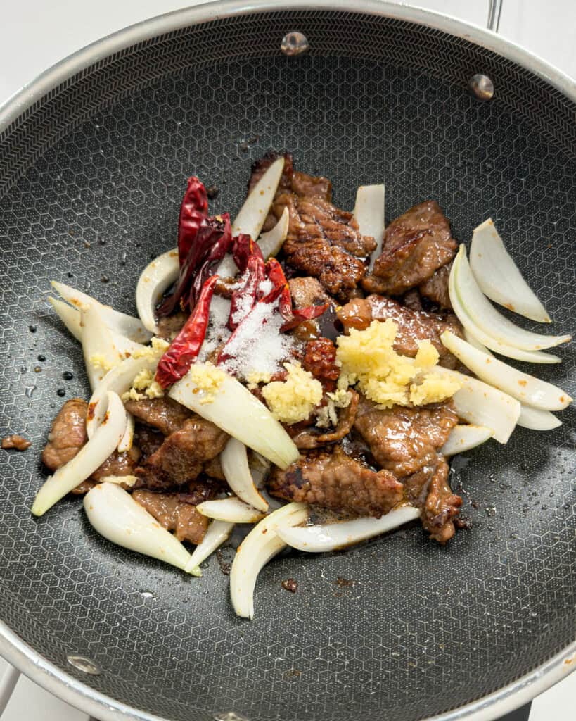 Aromatics and vegetables added to pan for Mongolian Beef Noodles stir-fry