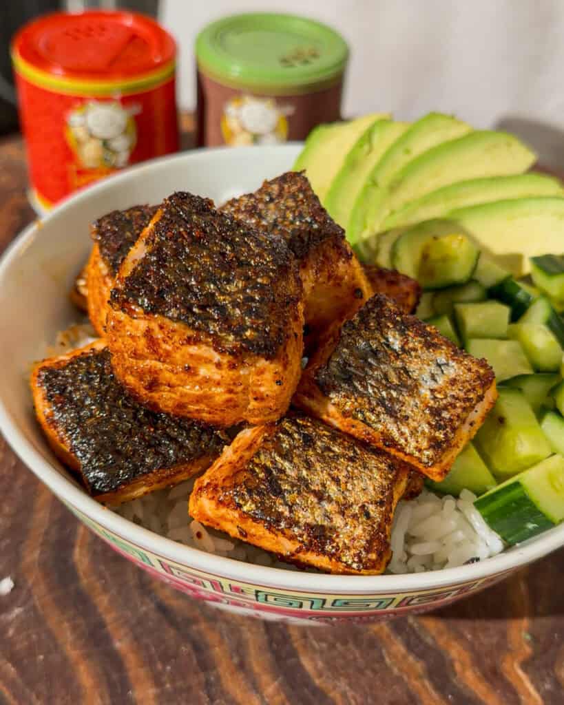 Bang Bang Salmon served over rice with avocado and cucumber