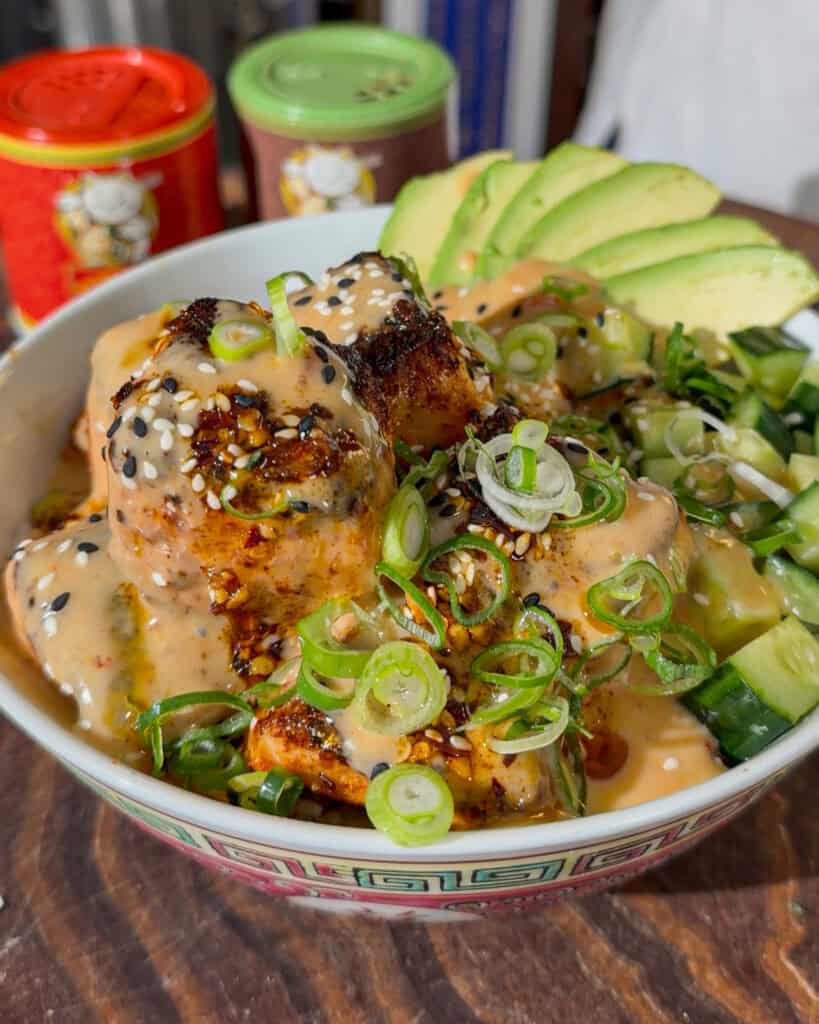 Bang bang sauce over salmon rice bowl ready to serve