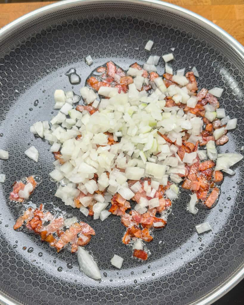 Chopped onion added to bacon in pan