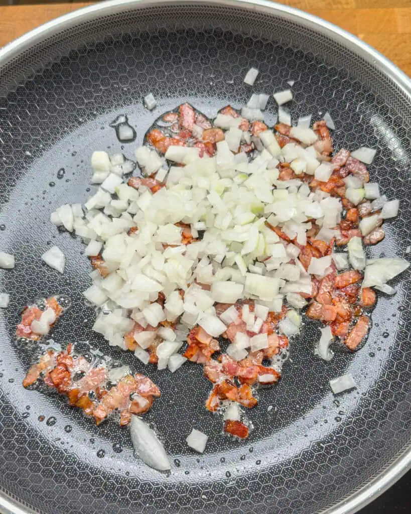Chopped onion added to bacon in pan - GENIUS EATS Chopped onion added to bacon in pan