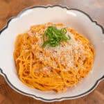 Delicious spicy pork stir-fry with tender meat and flavorful sauce on a wooden cutting board. Perfec.