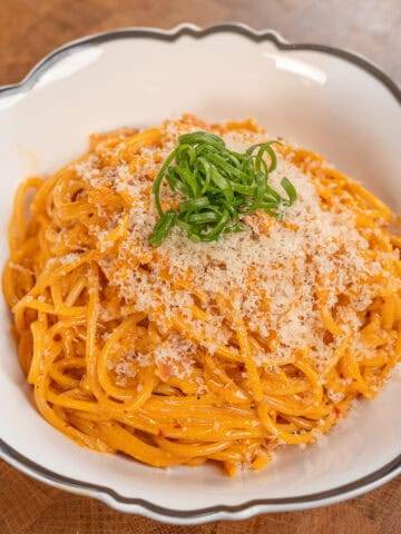 Delicious spicy pork stir-fry with tender meat and flavorful sauce on a wooden cutting board. Perfec.