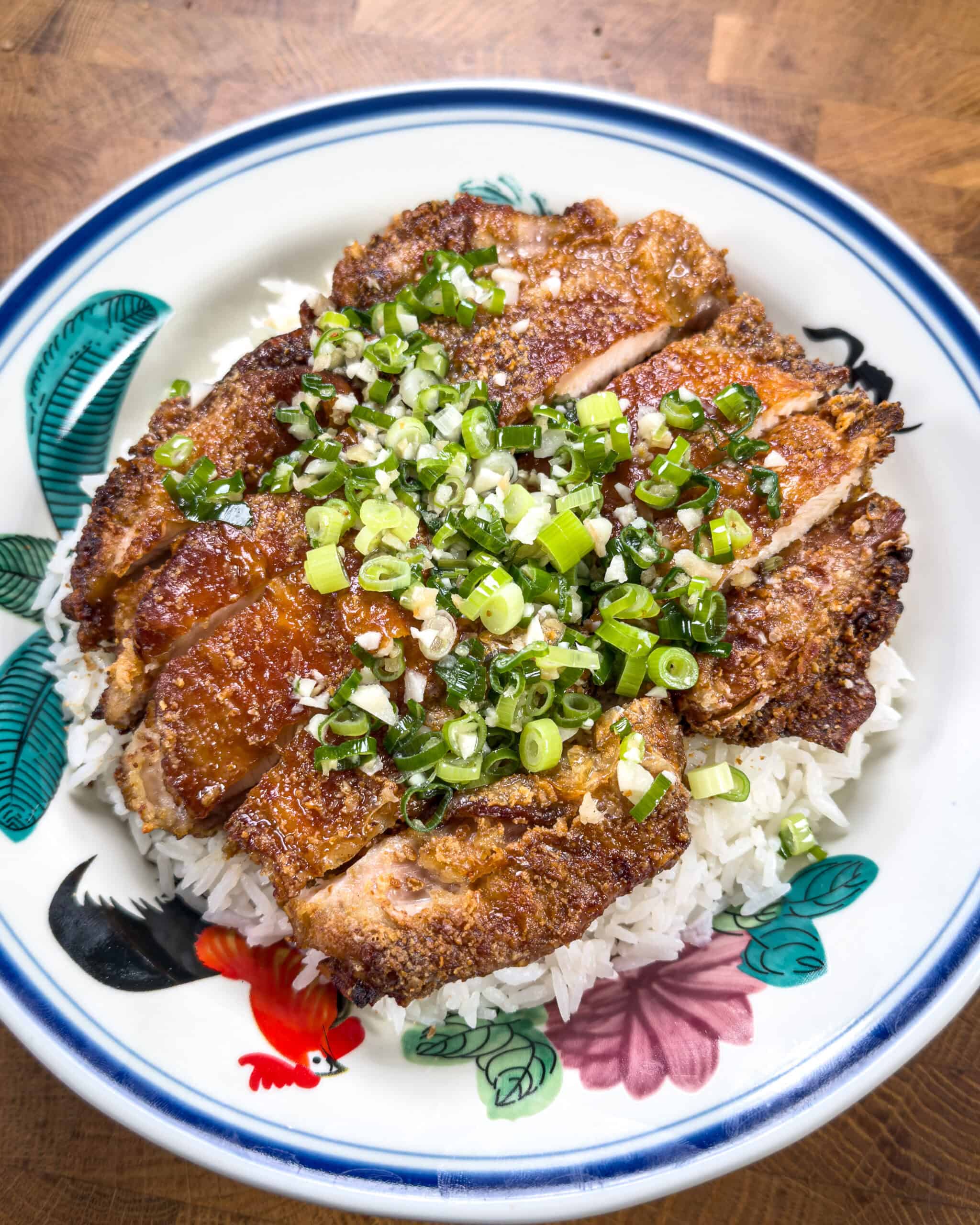 Crispy chicken served over rice with ginger scallion oil