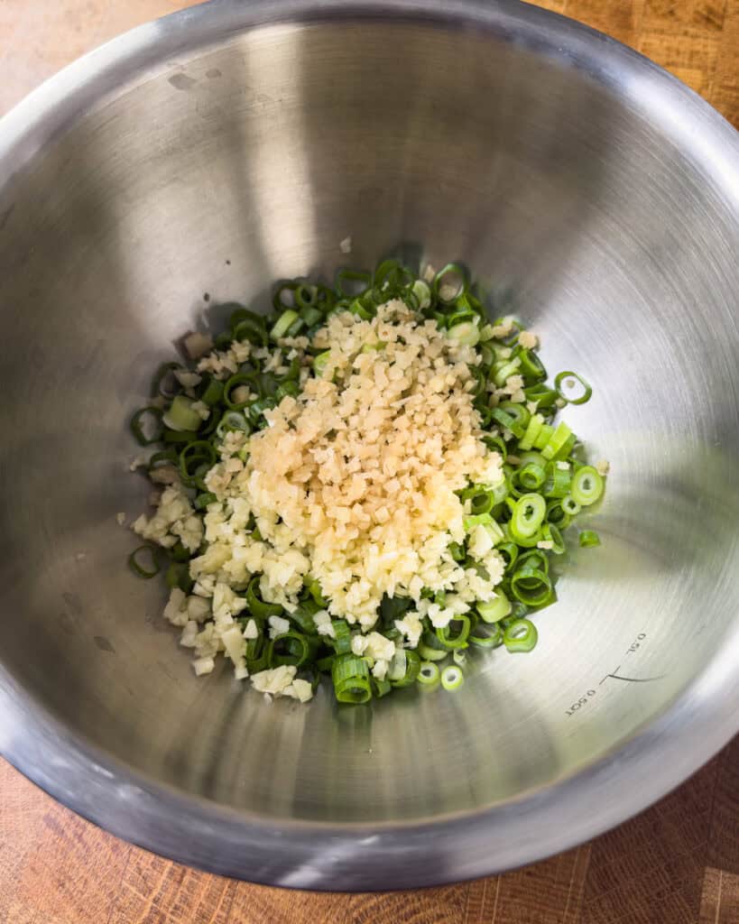 Minced garlic and chopped scallions prepared for ginger scallion oil