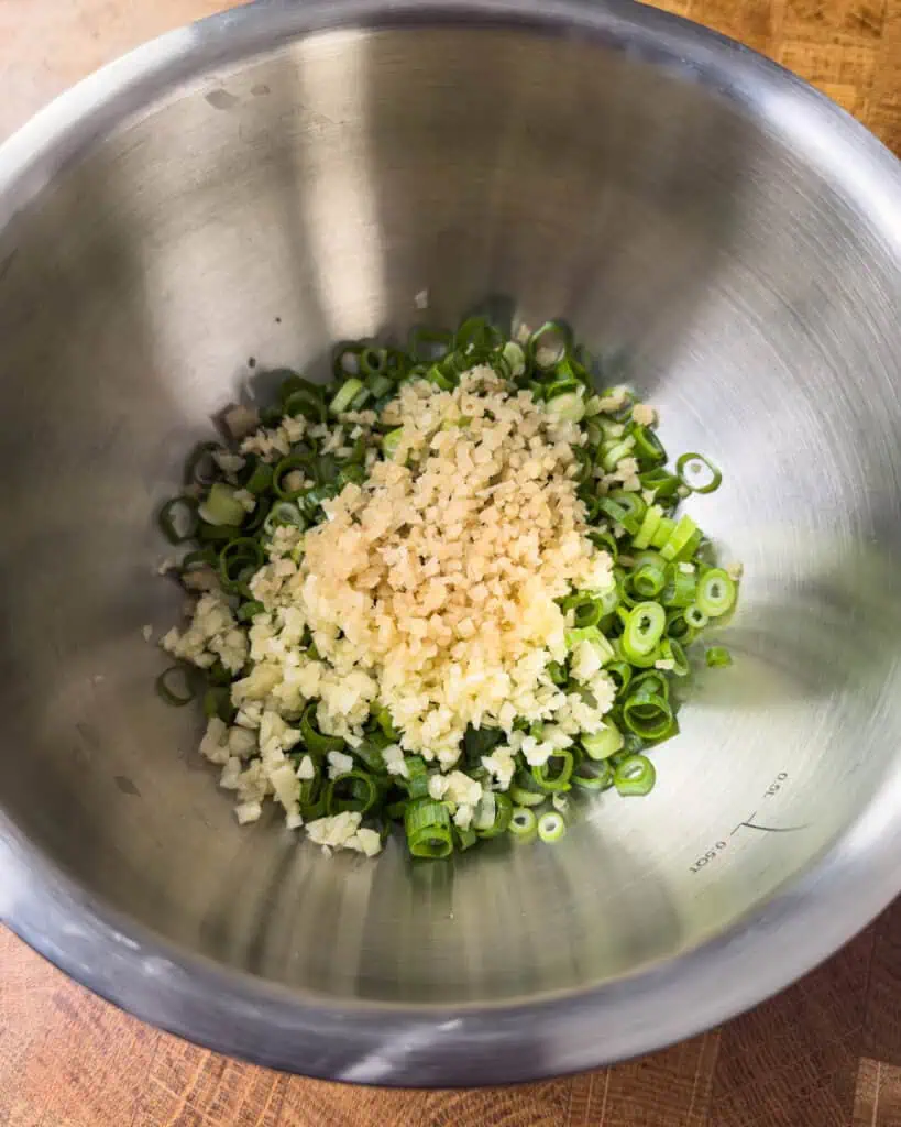 Minced garlic and chopped scallions prepared for ginger scallion oil - GENIUS EATS Minced garlic and chopped scallions prepared for ginger scallion oil