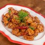 Delicious sweet and spicy chicken with sesame seeds and green onions. Perfect for a flavorful Asian-.