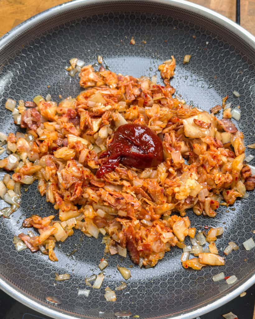 Onion and bacon mixed in pan with other ingredients