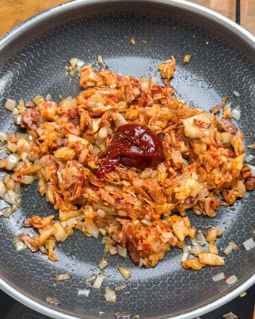 Onion and bacon mixed in pan with other ingredients - GENIUS EATS Onion and bacon mixed in pan with other ingredients