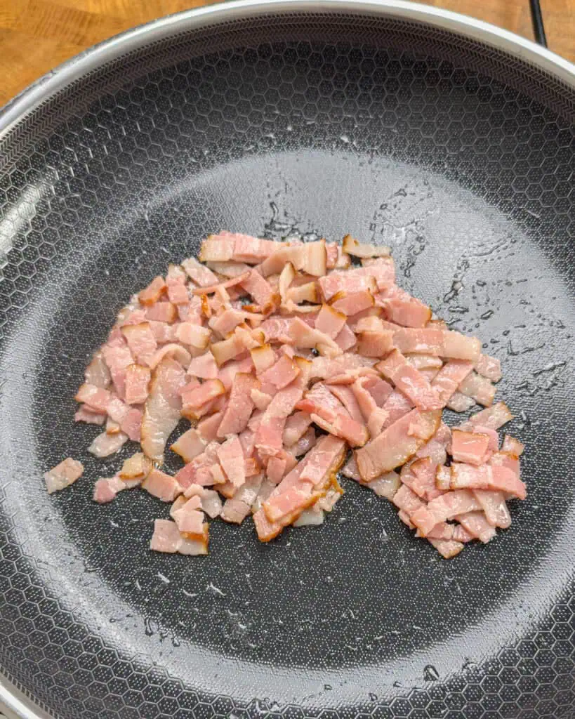 Raw bacon pieces spread in pan at the start of cooking - GENIUS EATS Raw bacon pieces spread in pan at the start of cooking
