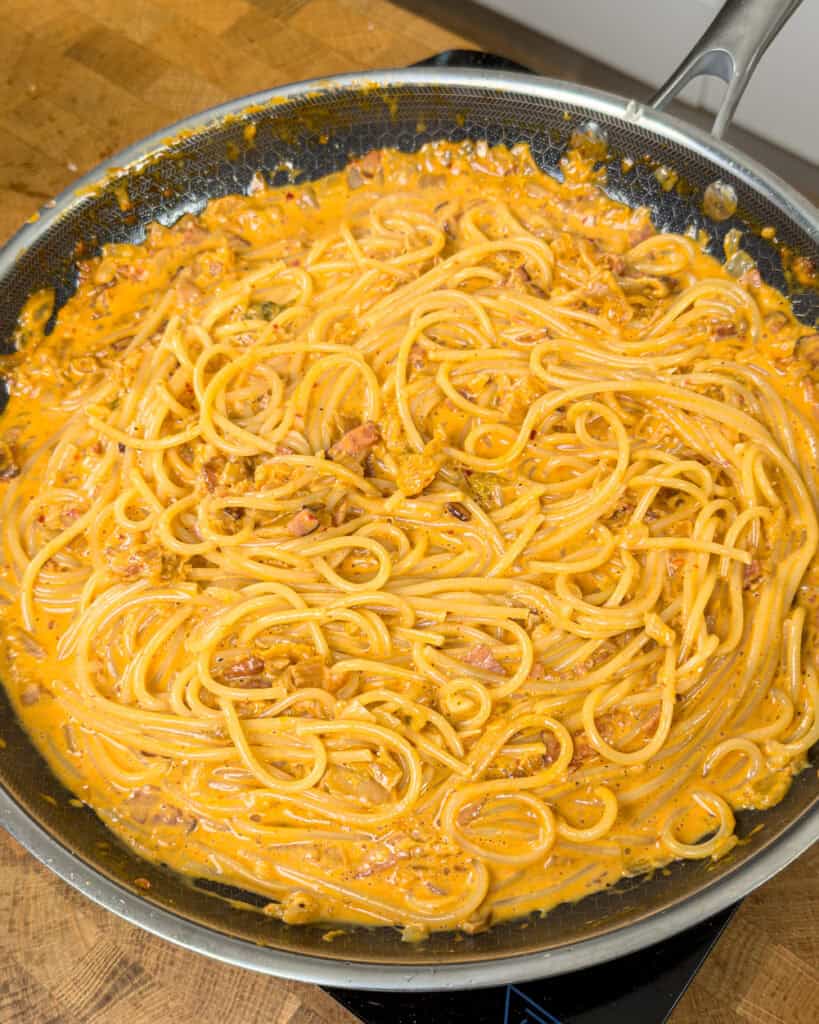 Spaghetti mixed through orange sauce