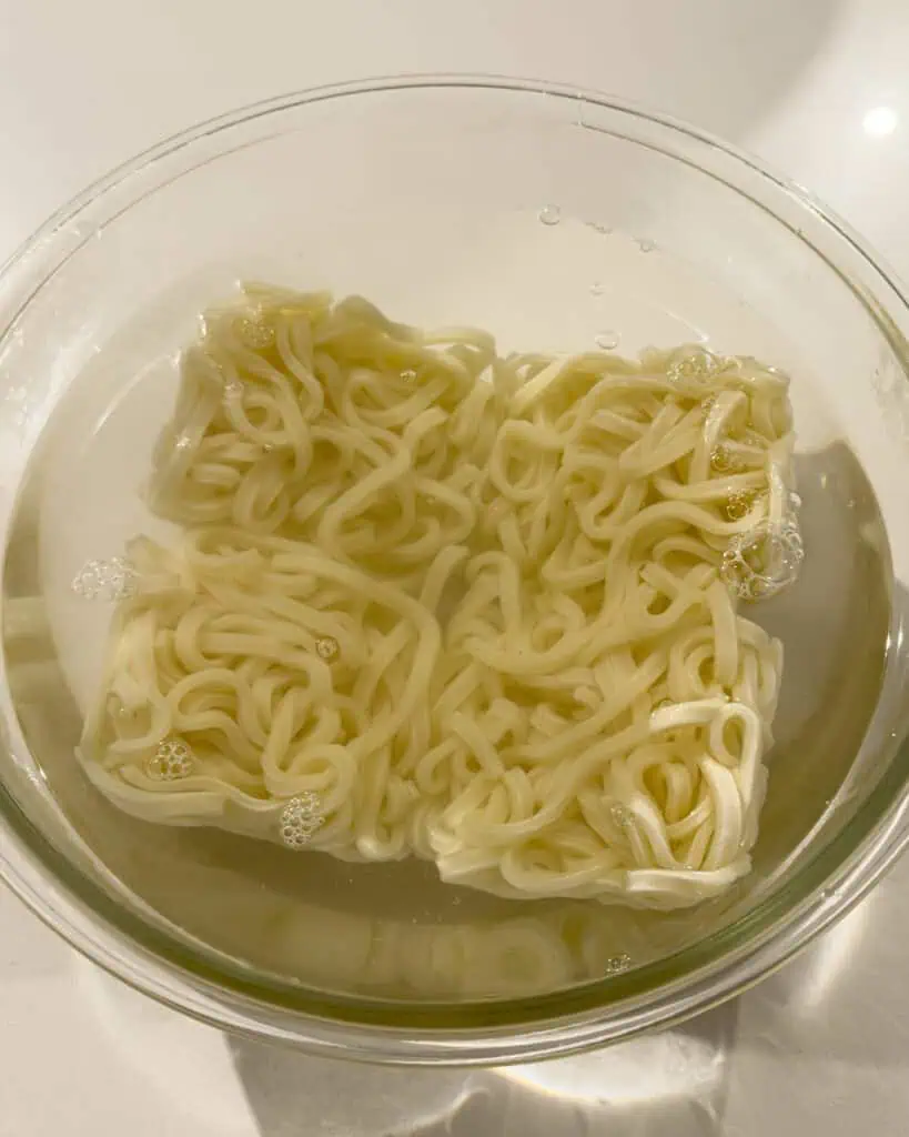 Udon noodles soaking in liquid - GENIUS EATS Udon noodles soaking in liquid