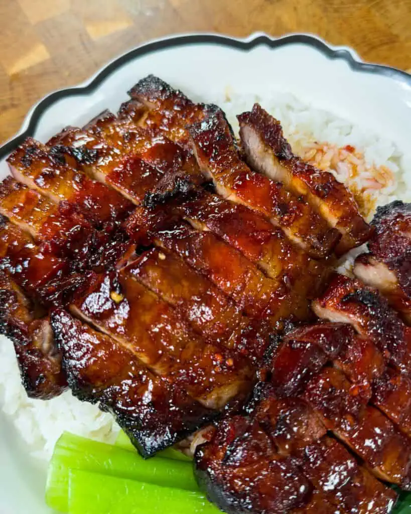 Close-up of sliced Char Siu Pork Belly showing glossy glaze - GENIUS EATS Close-up of sliced Char Siu Pork Belly showing glossy glaze