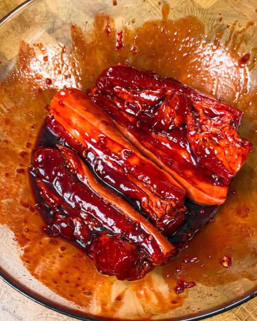 Marinated pork belly coated evenly in sauce before cooking Char Siu Pork Belly