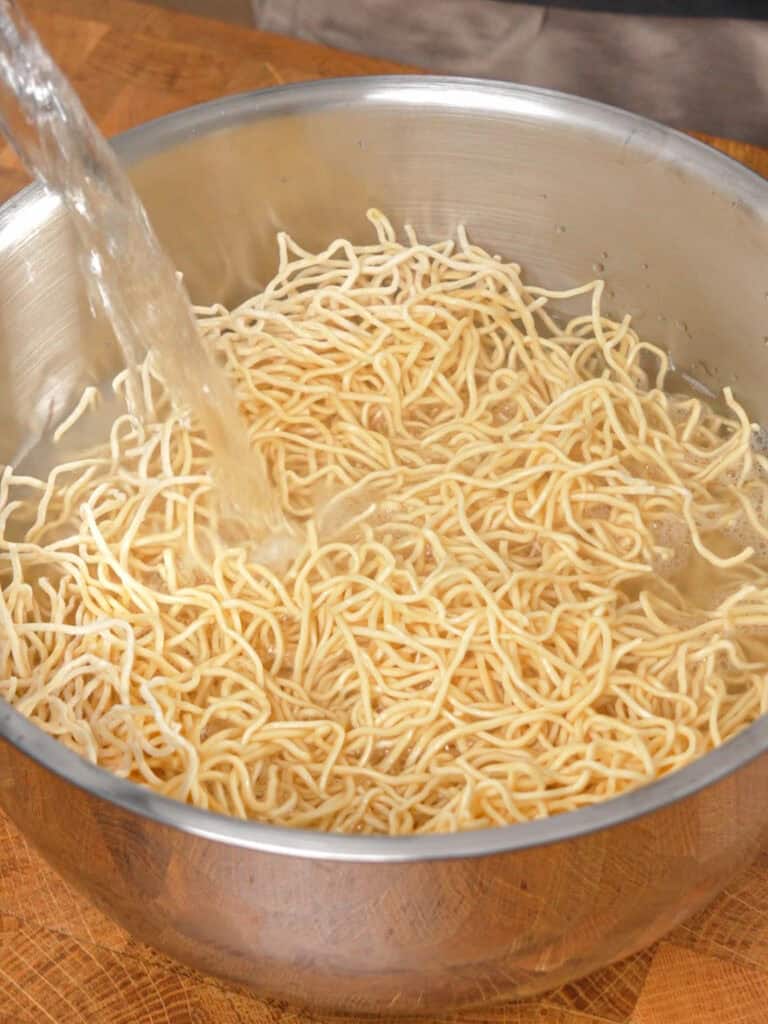 Chow mein noodles being soaked and prepared for General Tso-Style Chicken Chow Mein.