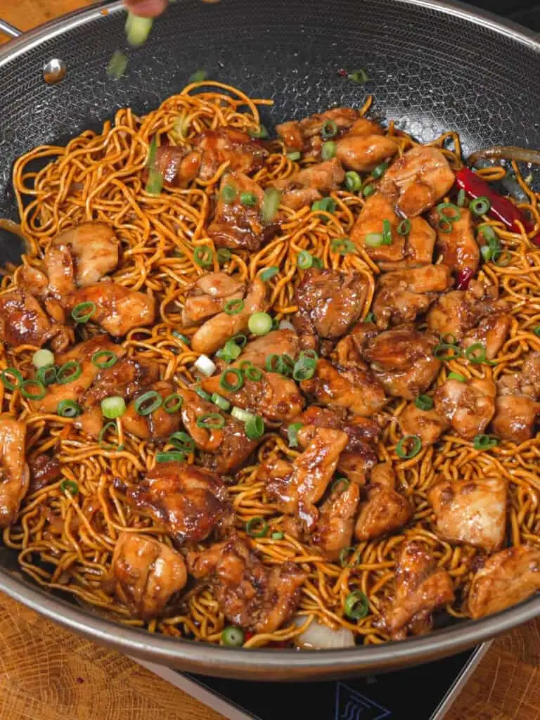 Fresh green onions added to General Tso-Style Chicken Chow Mein before serving - GENIUS EATS Fresh green onions added to General Tso-Style Chicken Chow Mein before serving