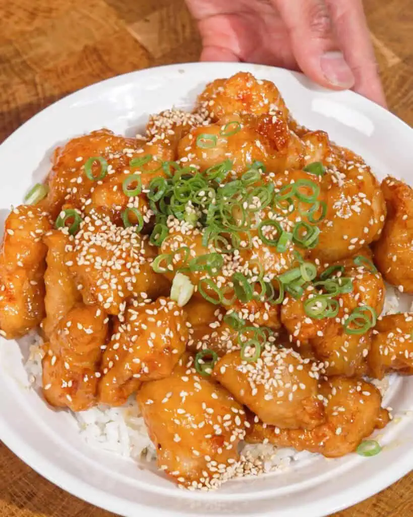 Honey Chicken served over white rice with sesame seeds and green onions - GENIUS EATS Honey Chicken served over white rice with sesame seeds and green onions