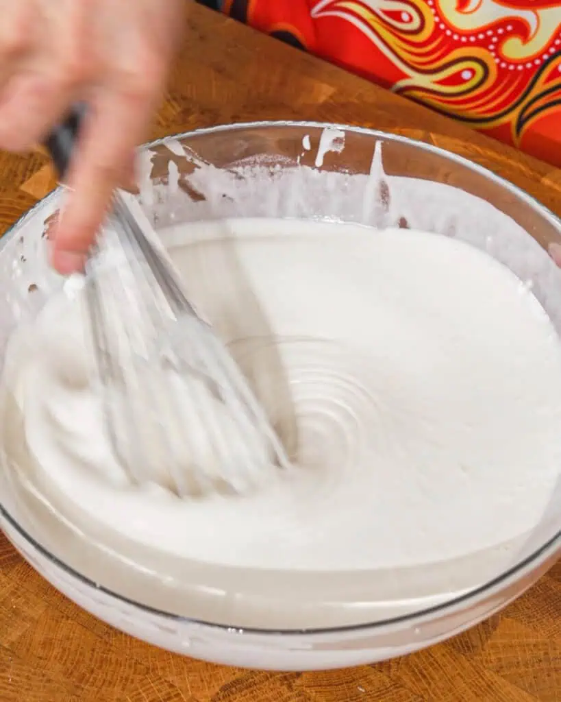 White batter being whisked in a glass bowl for Honey Chicken - GENIUS EATS White batter being whisked in a glass bowl for Honey Chicken