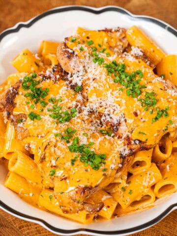 Gochujang chicken alfredo pasta plated and garnished with parsley and parmesan