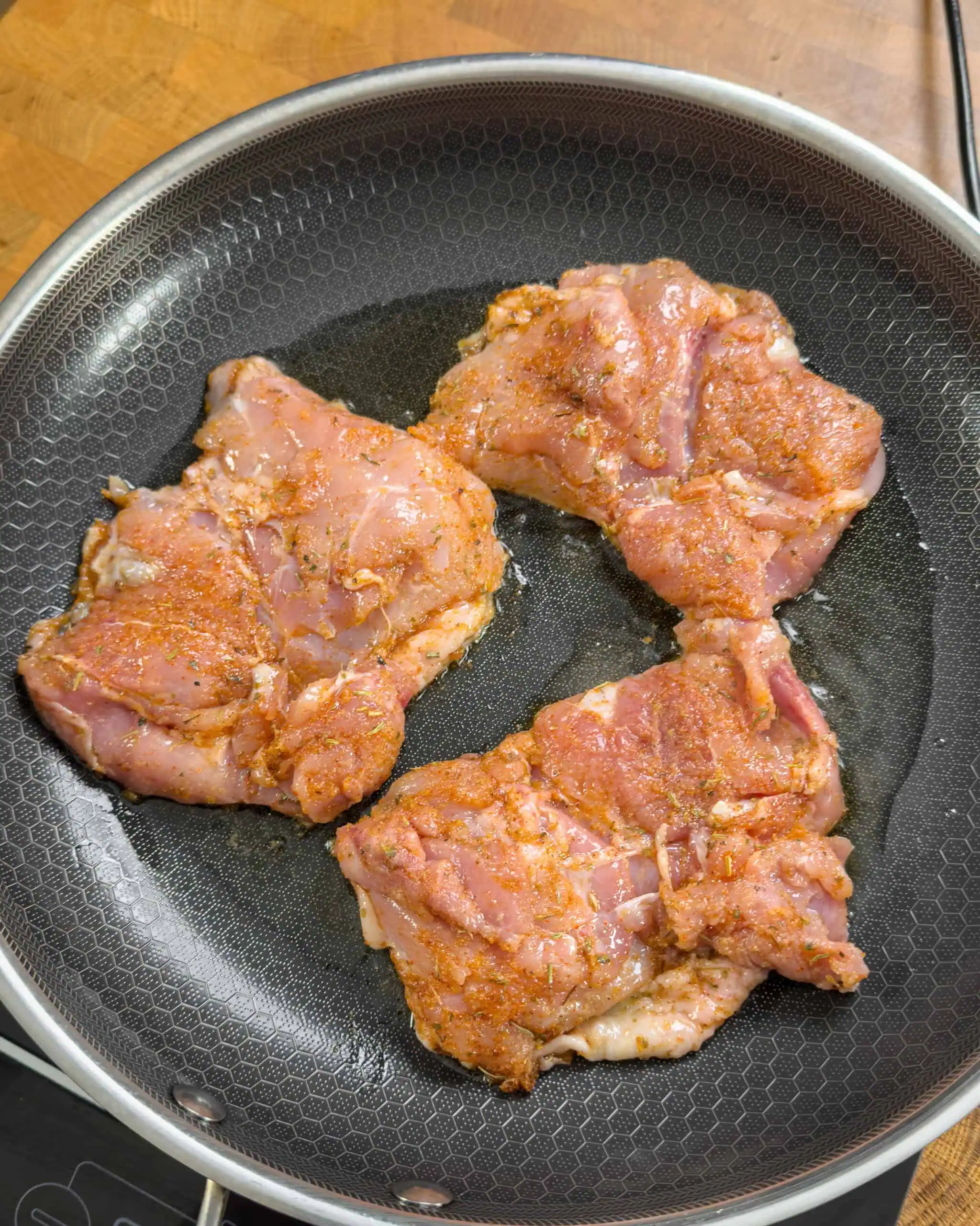 Chicken thighs searing in a hot pan - GENIUS EATS Chicken thighs searing in a hot pan