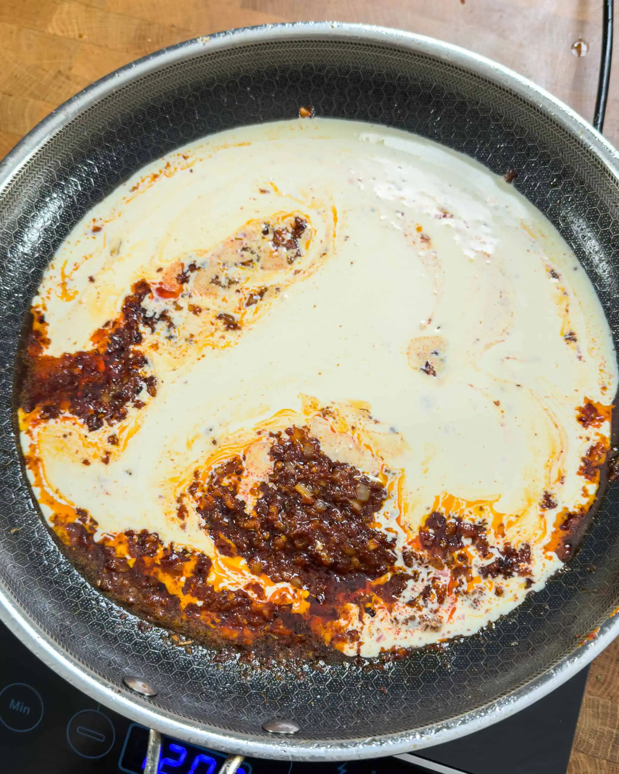 Adding heavy cream to the gochujang sauce base - GENIUS EATS Adding heavy cream to the gochujang sauce base