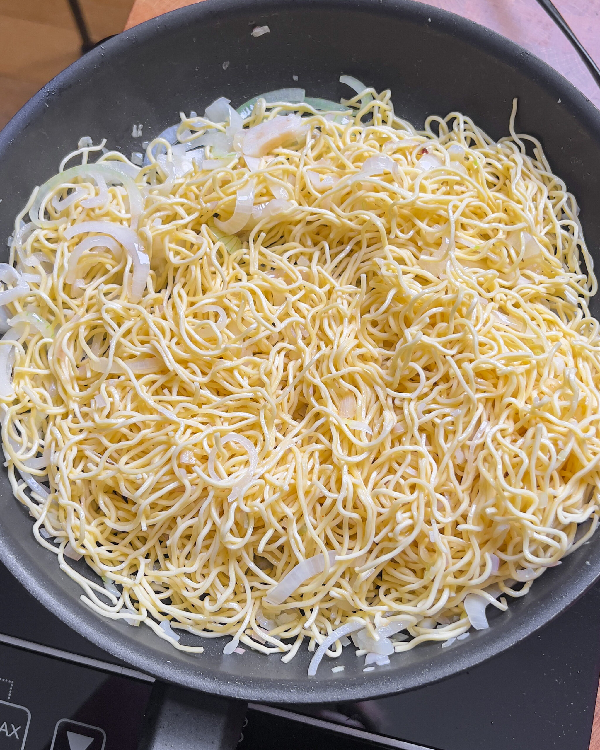 Soaked and drained egg noodles in a pan for Chili Oil Soy Sauce Chow Mein - GENIUS EATS Soaked and drained egg noodles ready for Chili Oil Soy Sauce Chow Mein