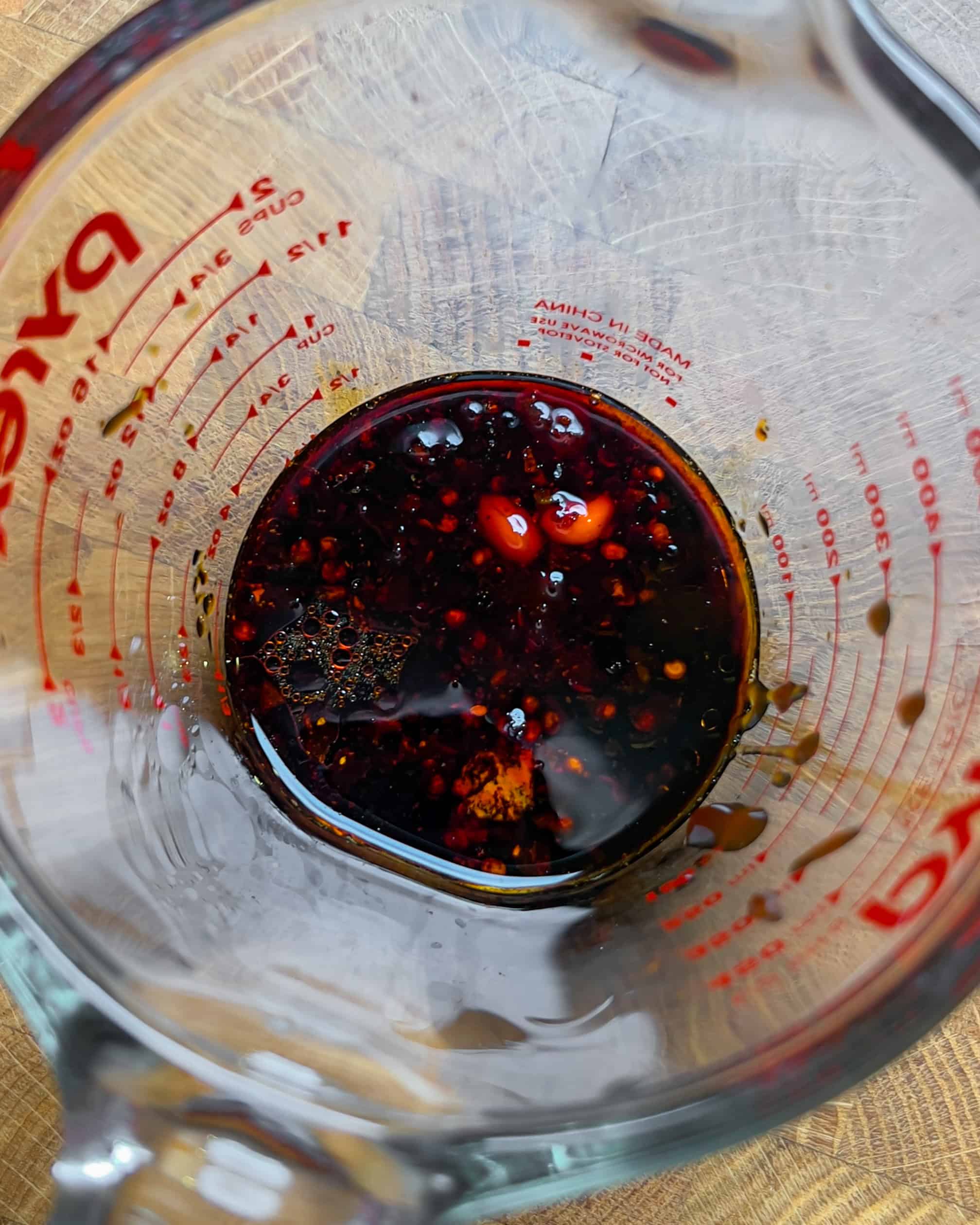 Soy sauce and chili oil sauce mixed in a measuring cup for Chili Oil Soy Sauce Chow Mein - GENIUS EATS Soy sauce and chili oil sauce mixed in a measuring cup for Chili Oil Soy Sauce Chow Mein