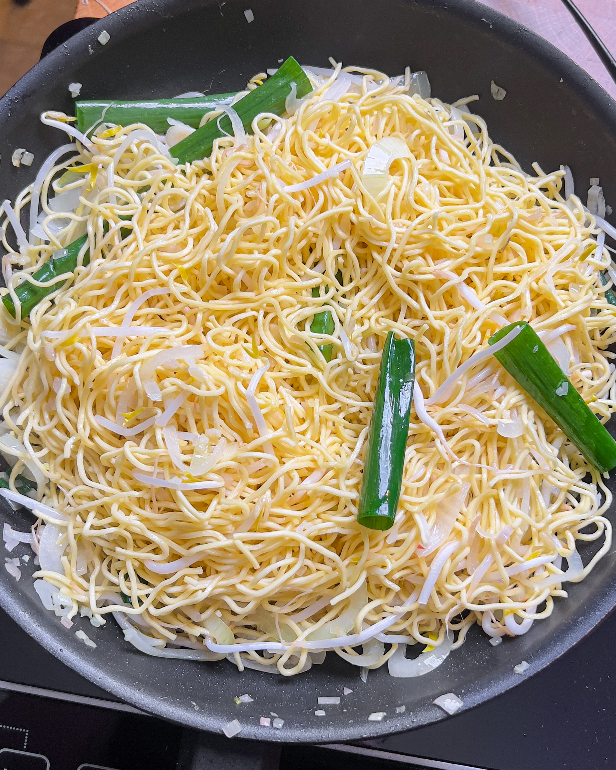 Tossing and separating the noodles in the pan for Chili Oil Soy Sauce Chow Mein - GENIUS EATS Tossing and separating the noodles in the pan for Chili Oil Soy Sauce Chow Mein